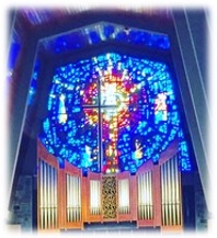 A group of people sitting in a room with a stained glass window

Description automatically generated with low confidence